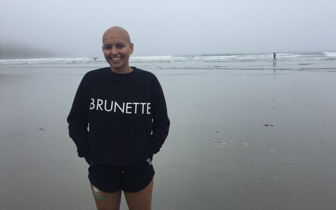 Alia bald standing in front of ocean